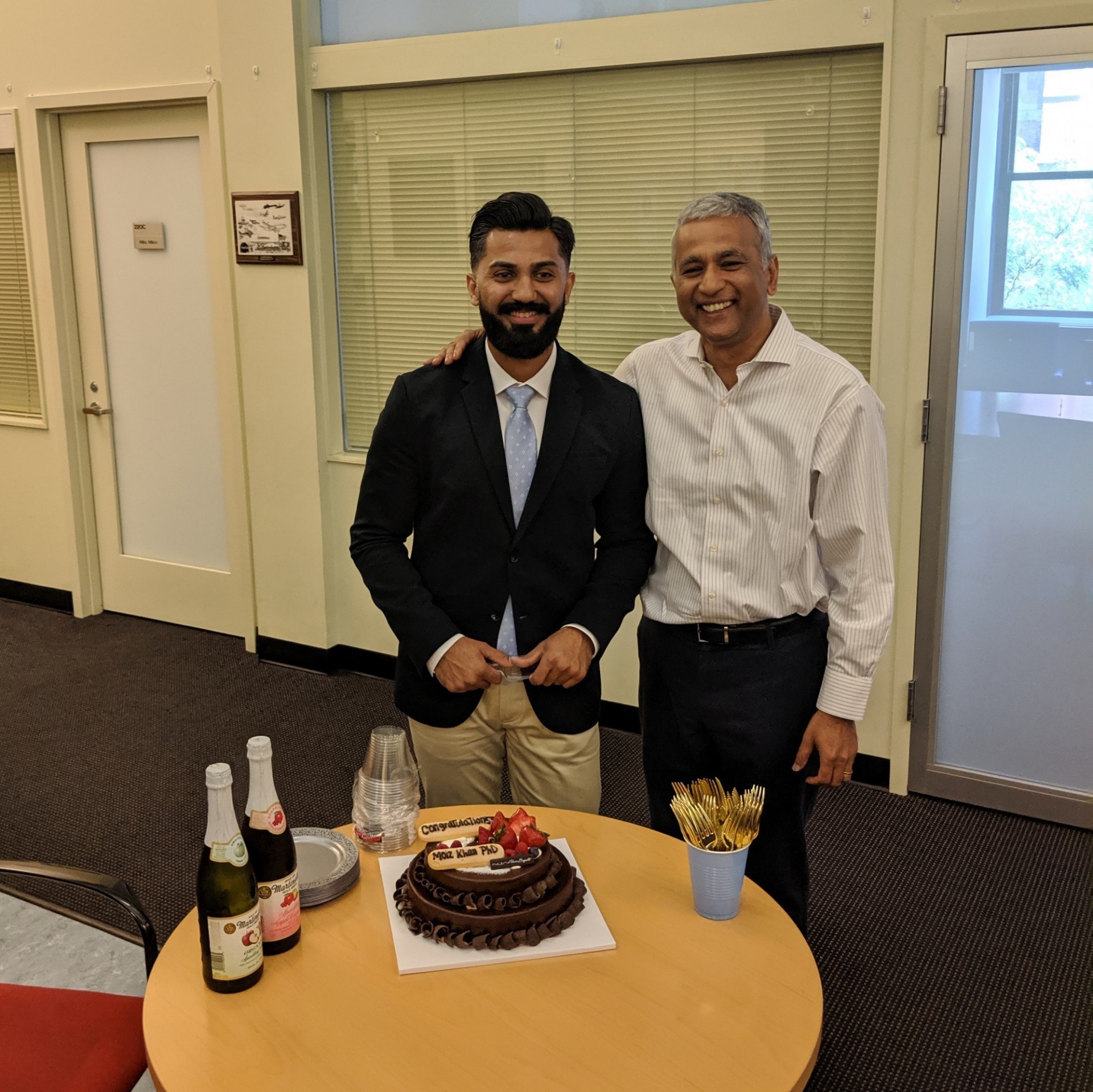 Dr. Khan and Dr. Agrawal celebrating with cake